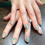 A close up of a hand with painted nails.