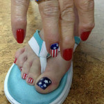 A woman with patriotic nail art on her toes.