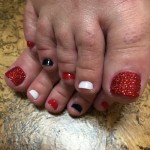 A woman's toes with red, white and blue nails.