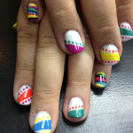 A girl with colorful nail designs on her hands.