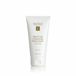 A tube of Eminence Organics Stone Crop Contouring Body Cream on a white background.