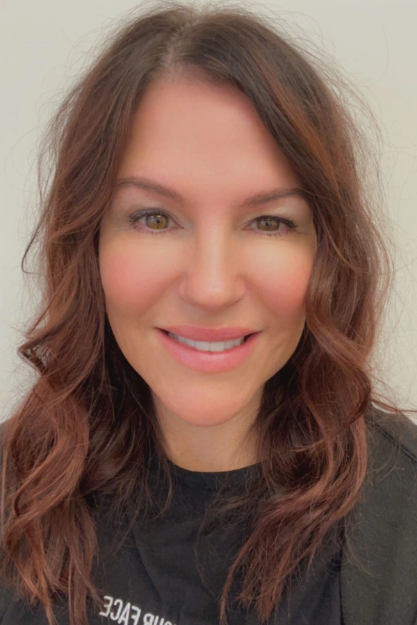 New Project A woman with long brown hair smiles for the camera.