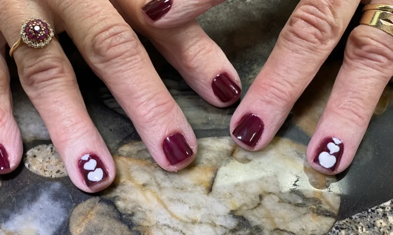 A close up of two hands with manicured nails