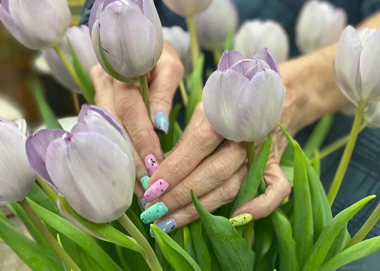 A person with their hands in flowers