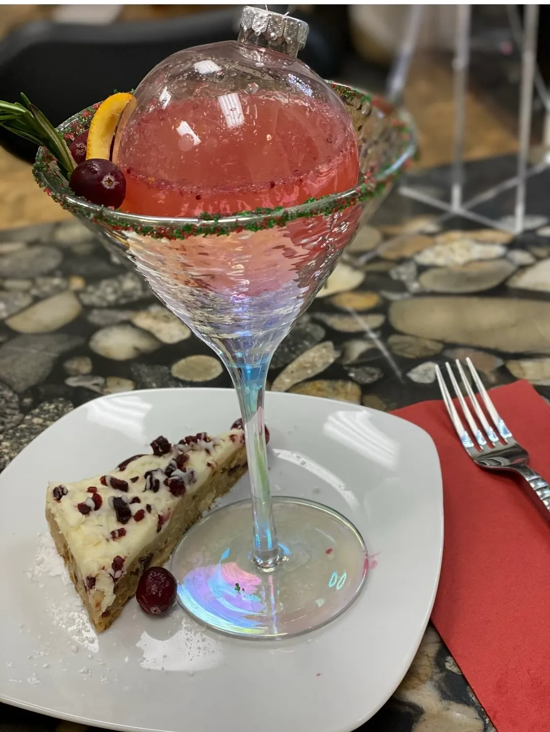 A glass of wine and cake on a plate.